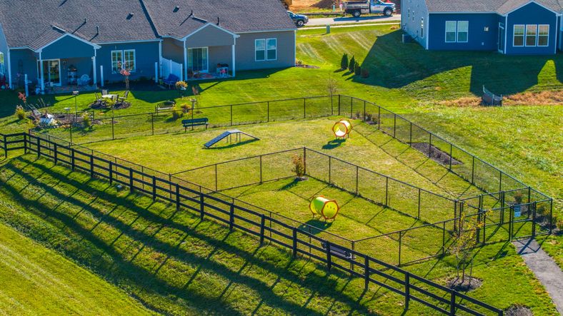 Drone photo of the exterior view of Rosehill Manor, with a large field and dog park.
