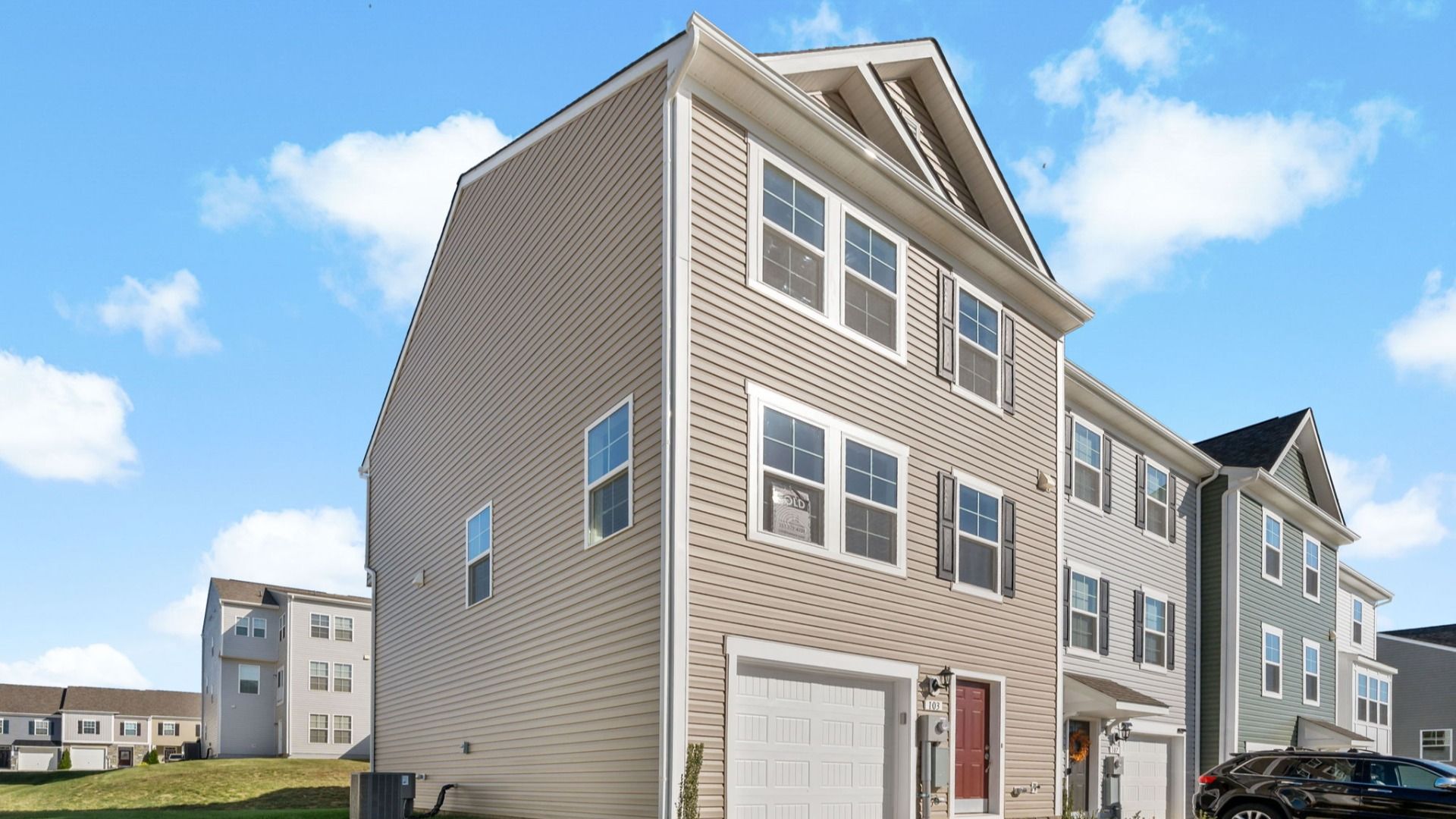Side exterior view of the York II floor plan at South Brook Townhomes by DRB Homes, located in Inwood, West Virginia.