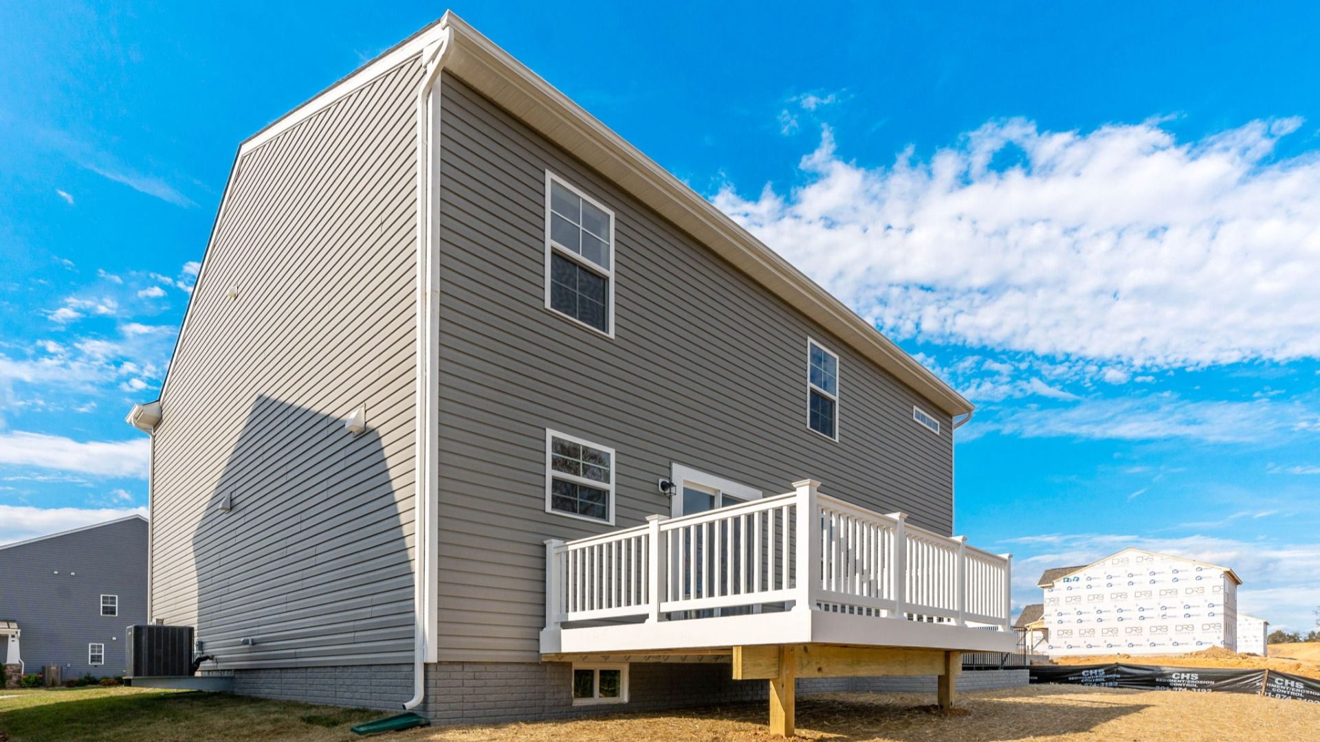 The back exterior of the Carnegie features a spacious deck with room for an outdoor living area.