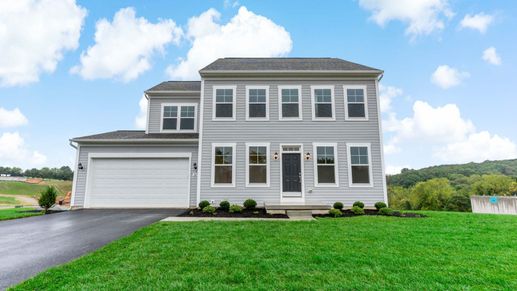 The front exterior view of the Newbury floor plan features a spacious garage and home design.