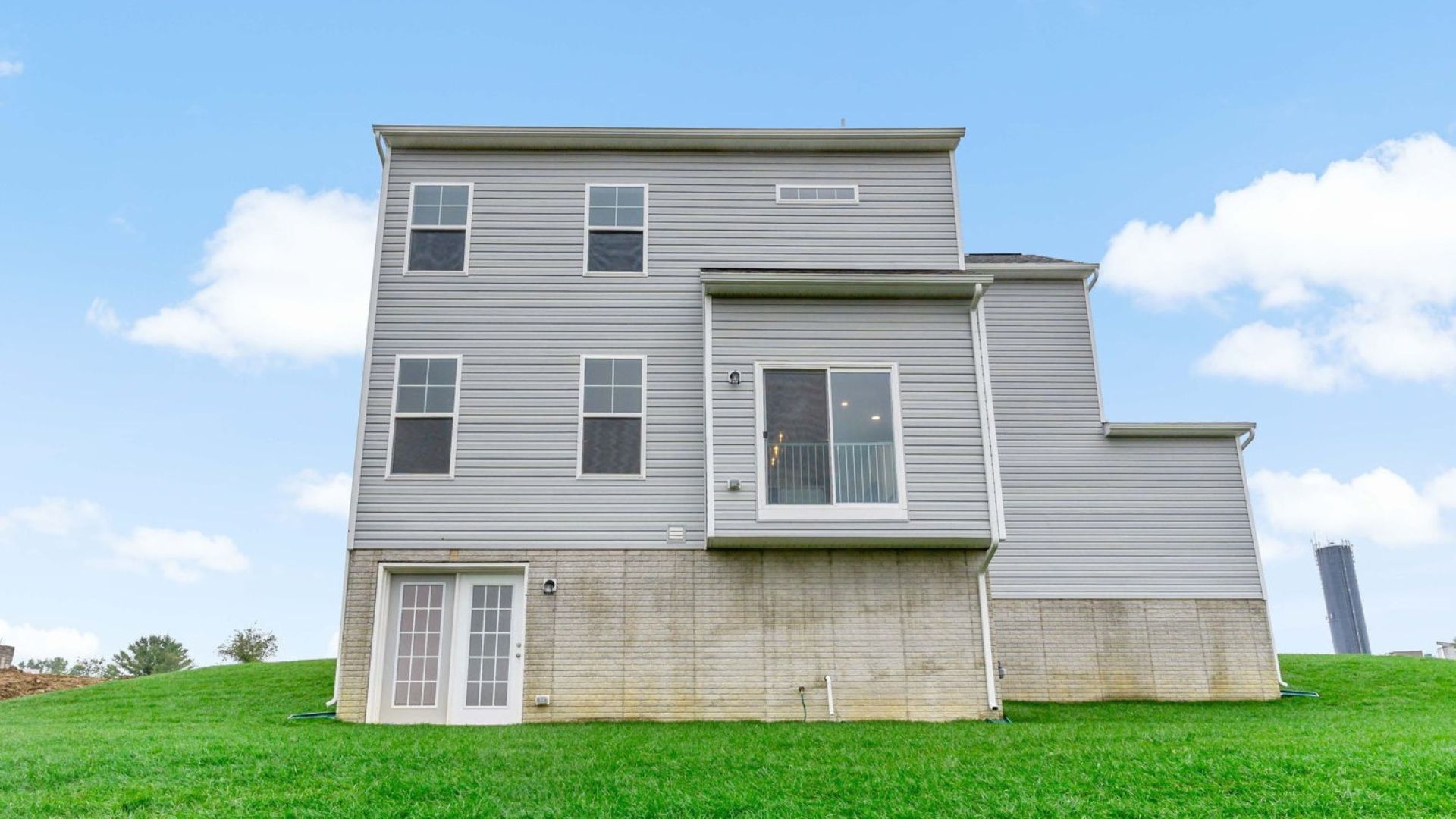 The back exterior of the Newbury features abundant windows and showcases the outdoor space.