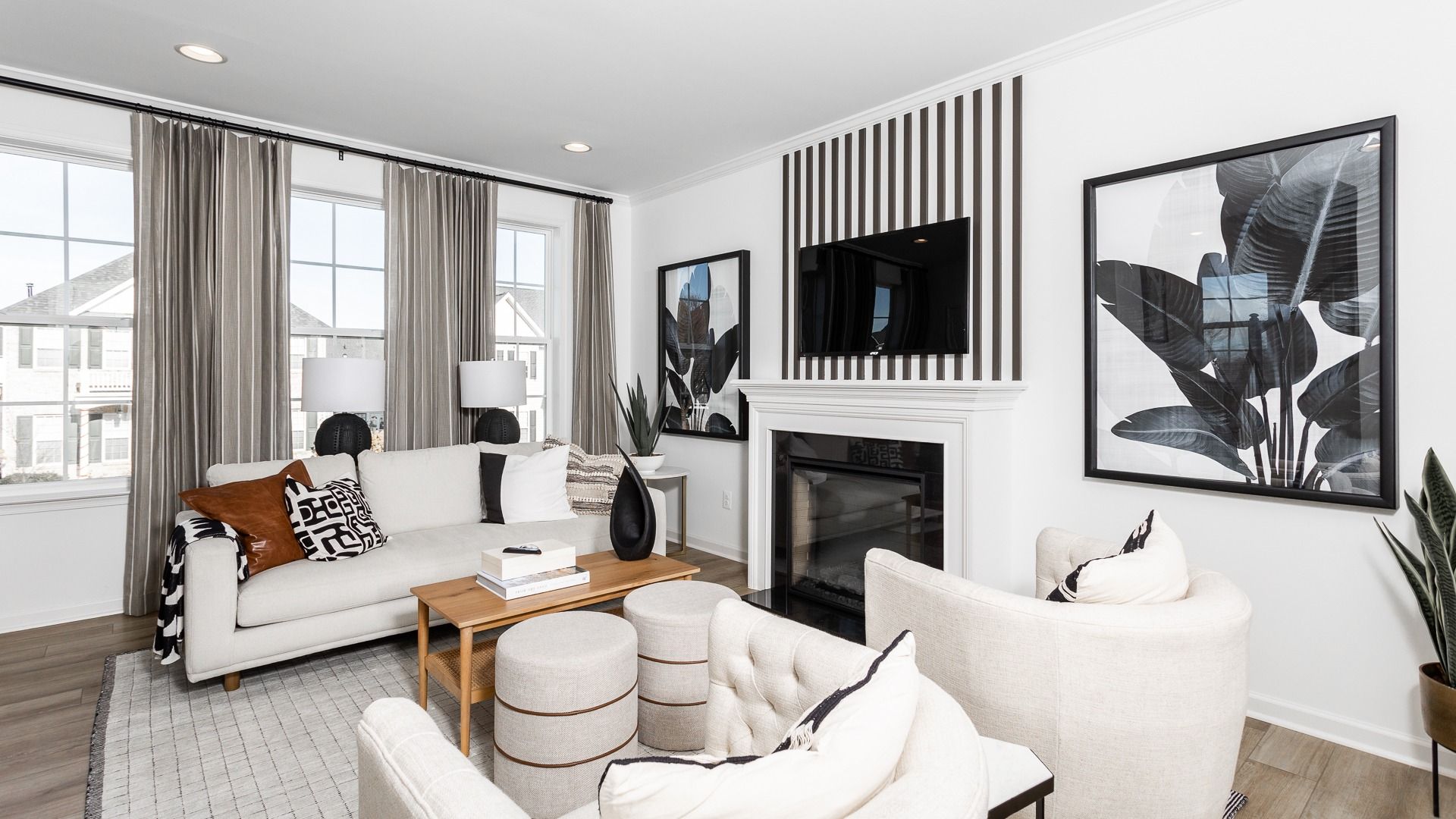 Relax in the inviting living room of the Bedford II, with cozy seating and a warm fireplace.