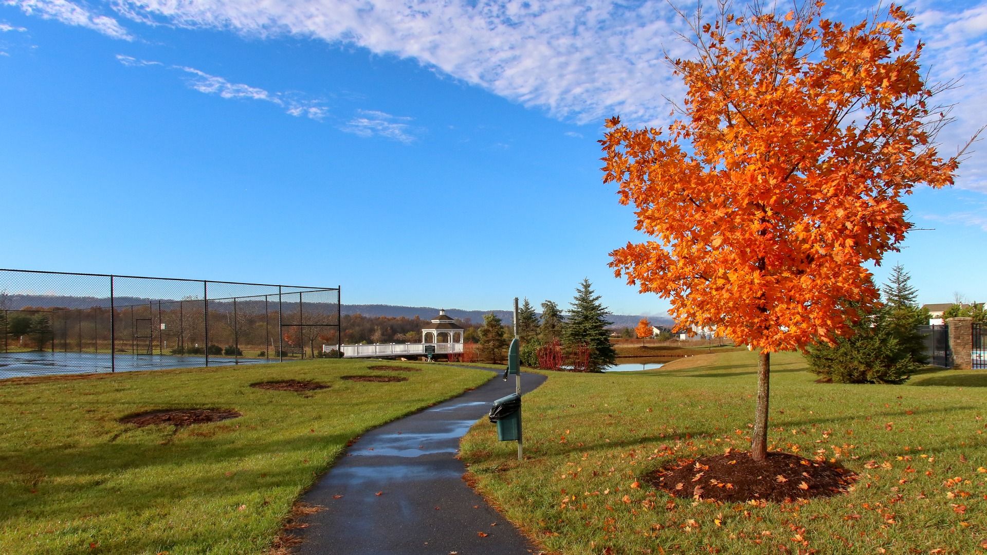 Autumn at Martinsburg Station, showcasing the community trail and tennis courts.