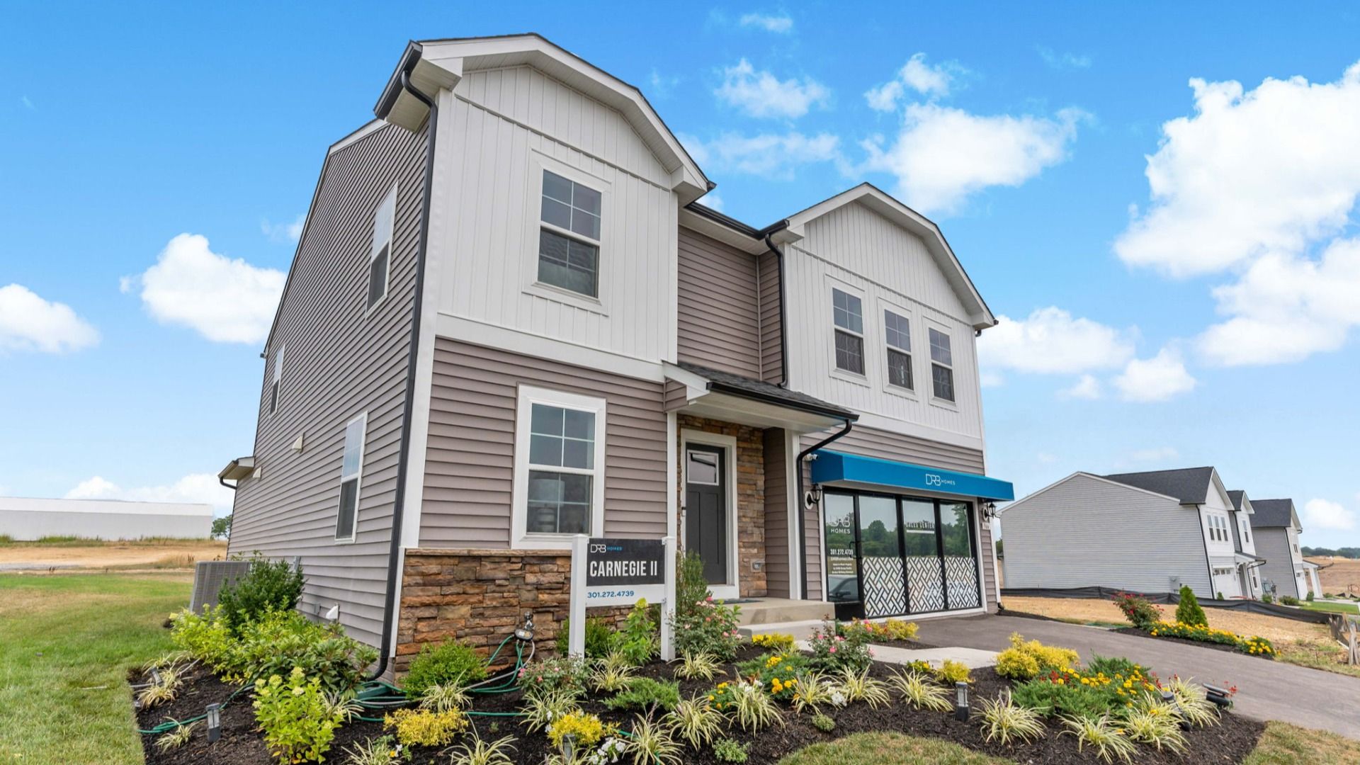 Side exterior view of Carnegie floor plan at South Brook Single Family Homes by DRB Homes, located in Inwood, West Virginia.