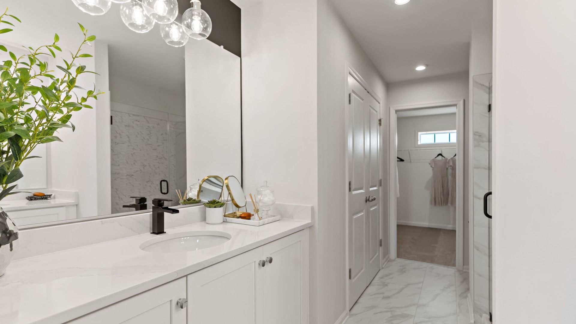 The Edgewood II features a sleek primary bath with a spacious vanity and modern finishes.