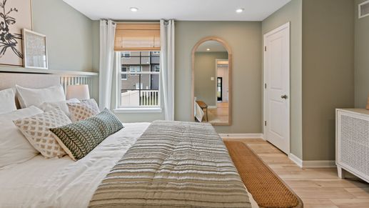 The Whitehall II floor plan features a calming primary bedroom with soft hues and cozy textures.