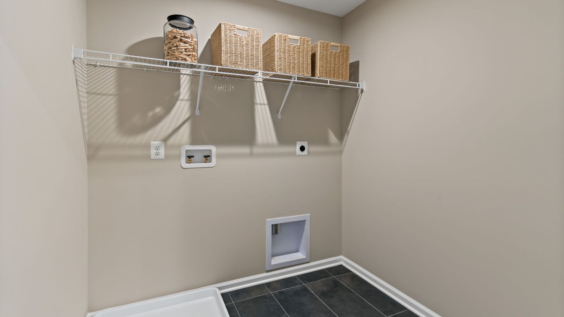 The laundry room in the Carnegie II is designed for organization to create a functional space.