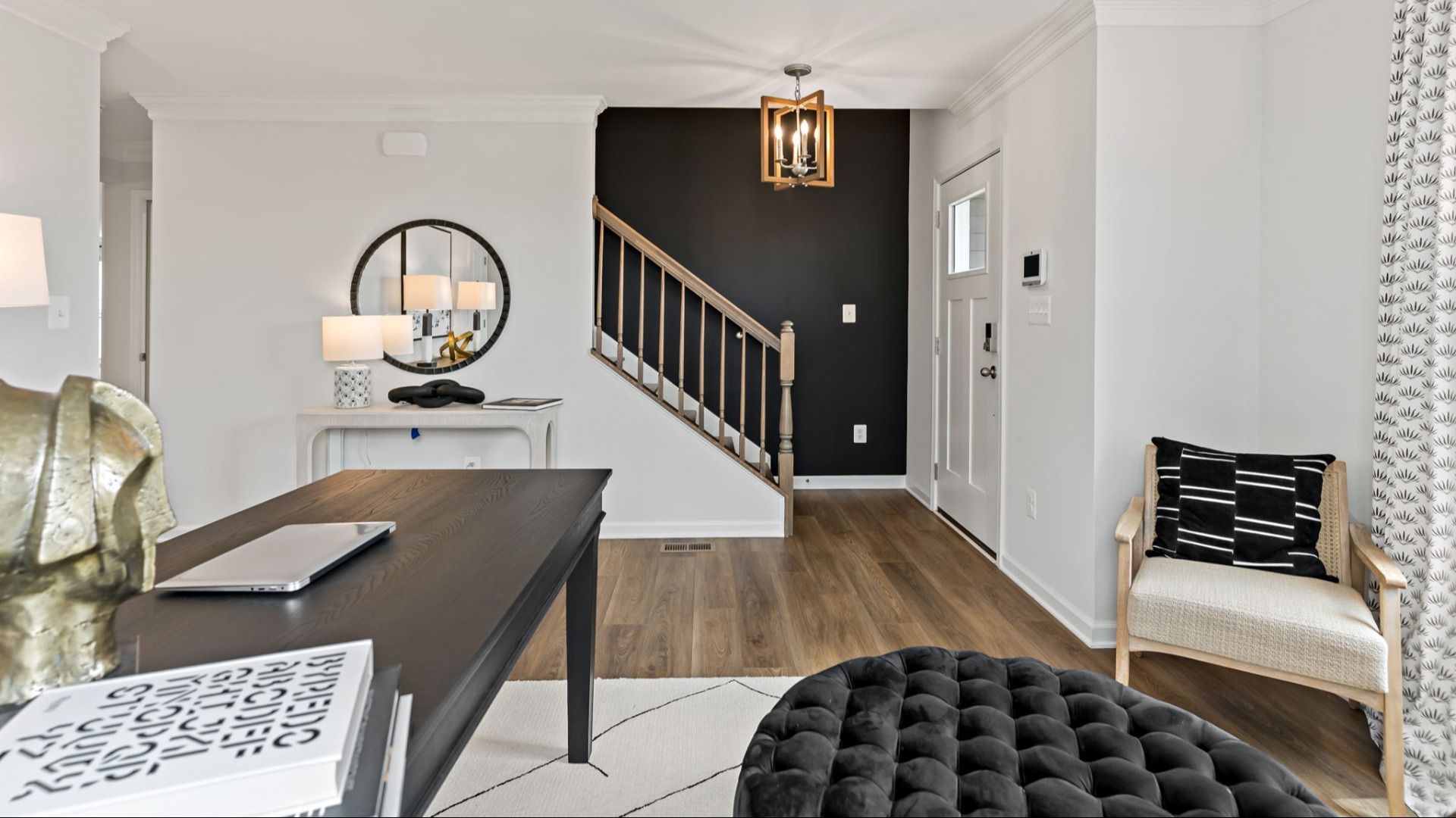 Stylish home office in the Carnegie II floor plan with warm wood flooring.
