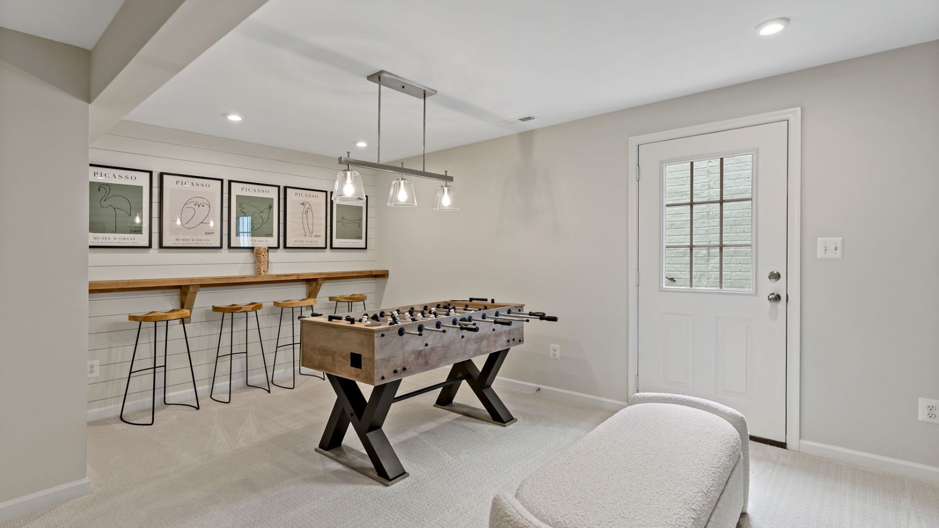 The Whitehall II floor plan offers a game room large enough for a foosball table and bar seating.
