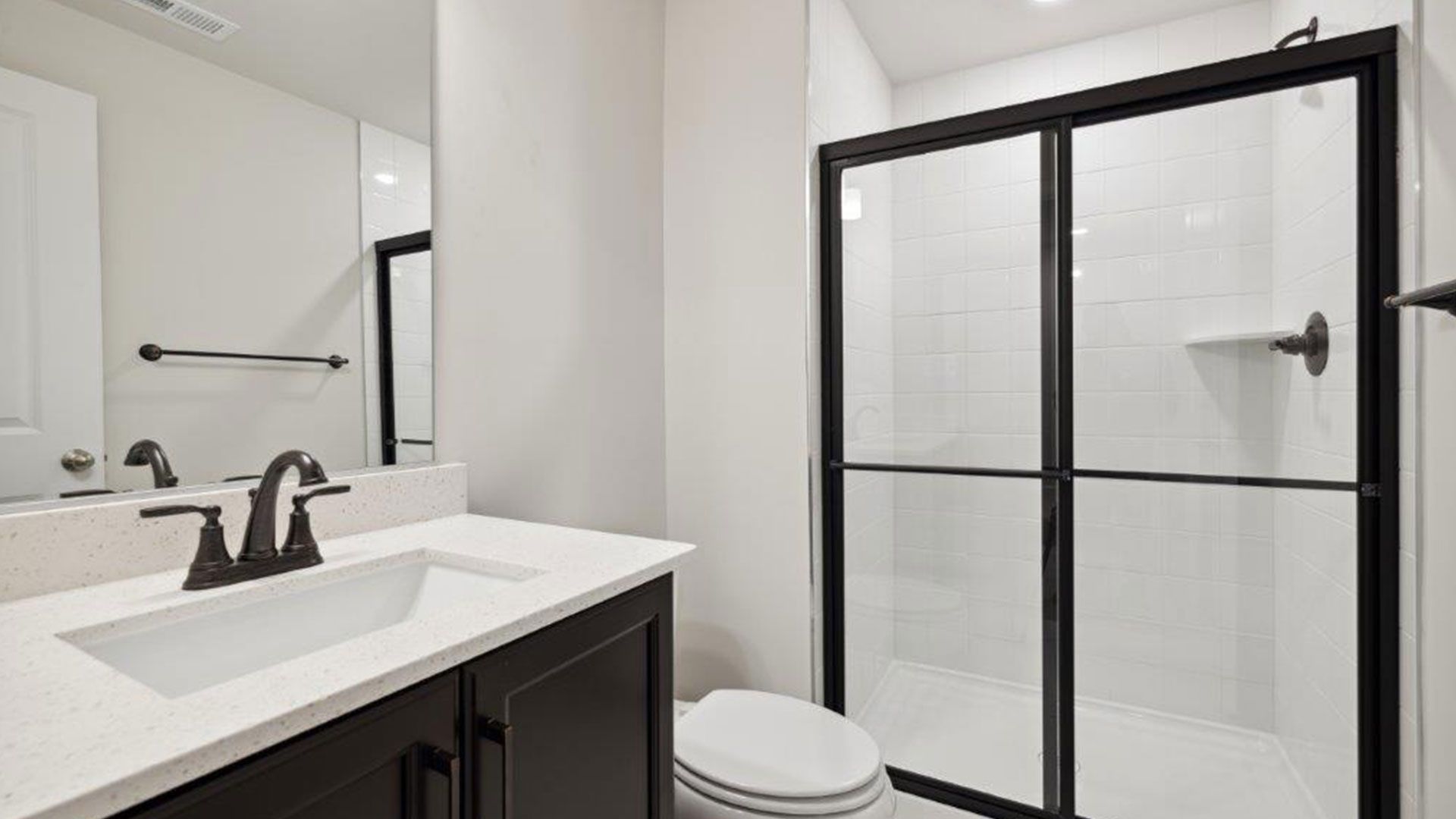 The Carnegie II floor plan offers a full bath with a sleek sink, toilet, and a spacious shower.