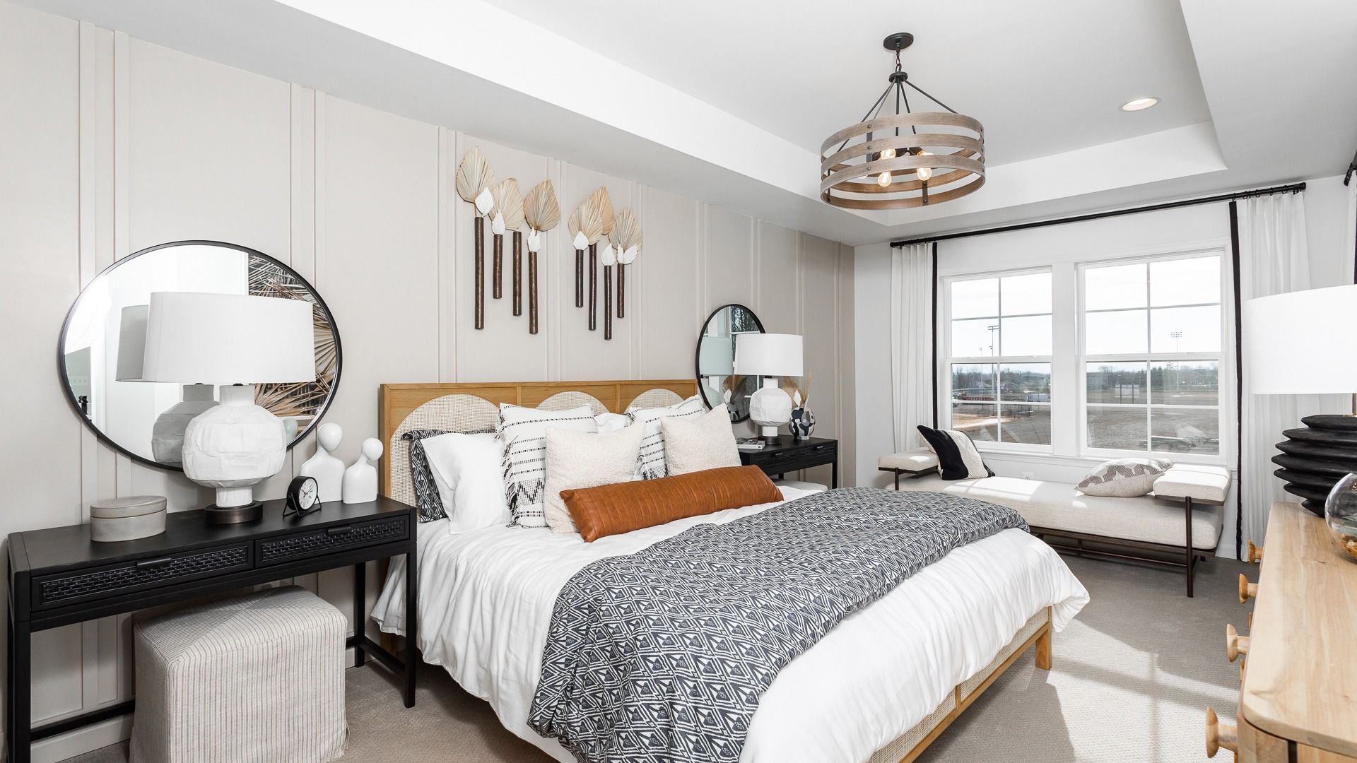 Owner's bedroom with vertical paneling, a modern light fixture, and neutral flooring.