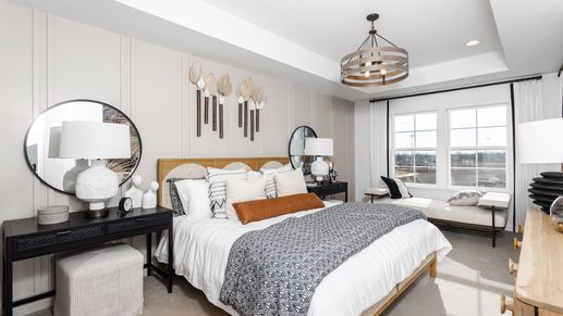 Owner's bedroom with vertical paneling, a modern light fixture, and neutral flooring.