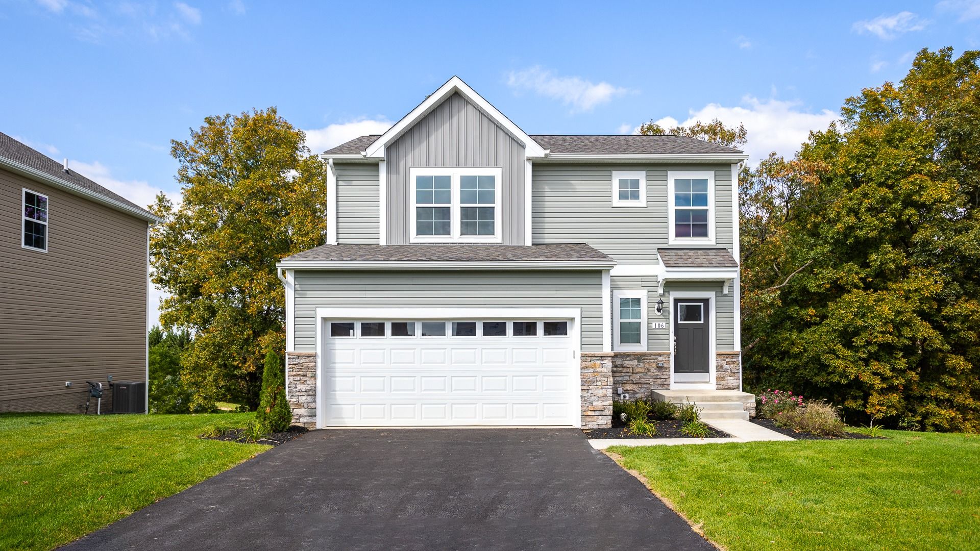 The Glenshaw II offers timeless appeal with stone accents, a covered entry, and a two-car garage.