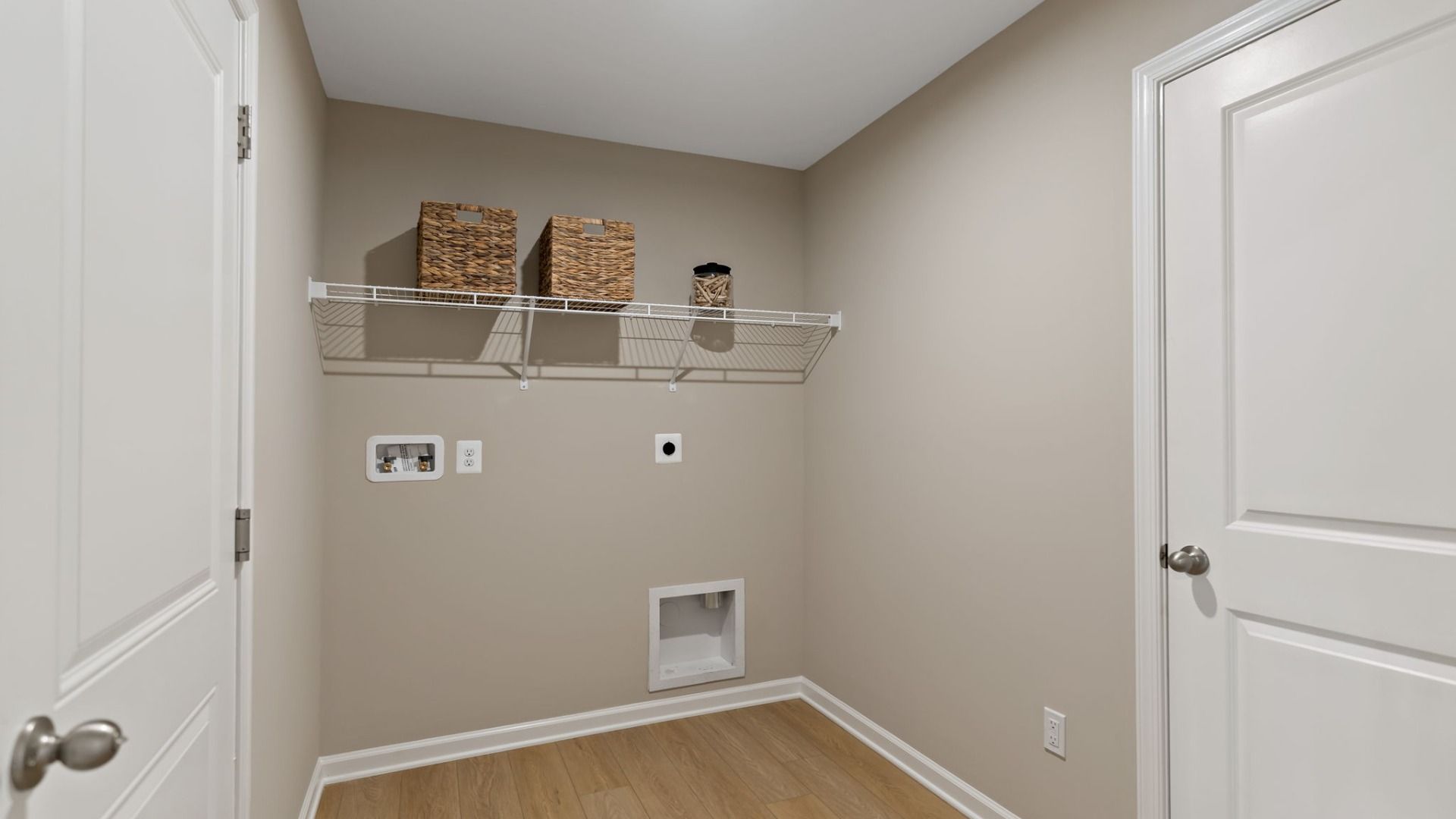 Efficient laundry room with shelving and space for washer/dryer in the Edgewood II floor plan.