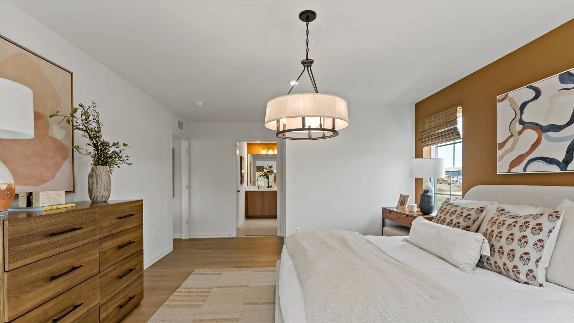 The owner’s suite in the Edgewood II with sleek lighting and a seamless flow into the private bath.