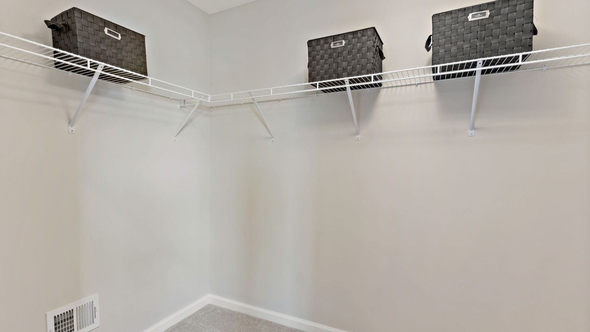 A spacious closet with wire shelving and neatly placed storage baskets in the York II Garage floor plan.