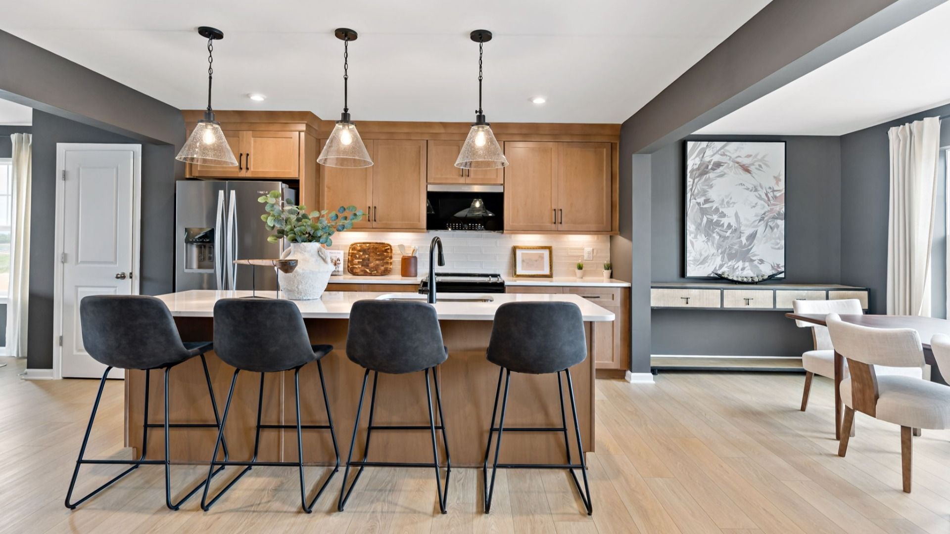Kitchen with pendant lighting, sleek countertops, and an open dining space in the York II Garage at The Gallery.