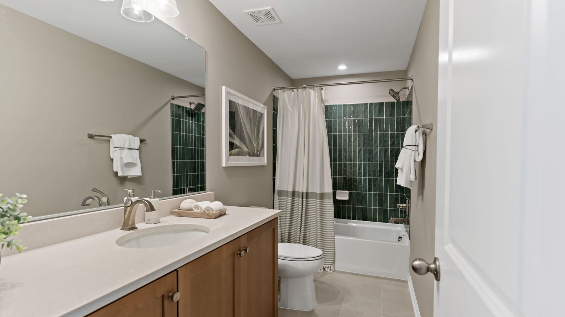 A hall bath featuring a sleek vanity and quartz countertop in the Whitehall II floor plan.