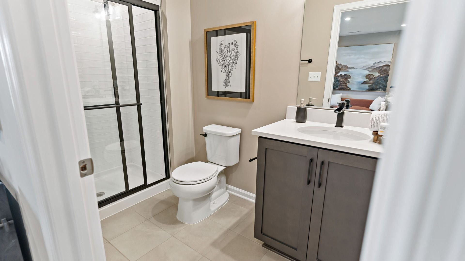 A spacious shower with sleek fixtures in a York II Garage floor plan bathroom.