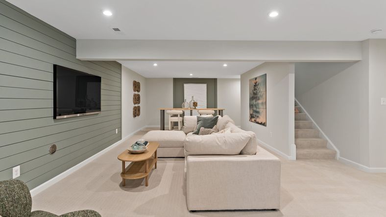 The Whitehall II’s finished lower level blends comfort and style with a lounge, TV, and bar.