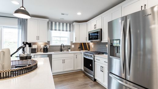 The Carnegie II kitchen is bright and functional, featuring stainless steel Whirlpool appliances.