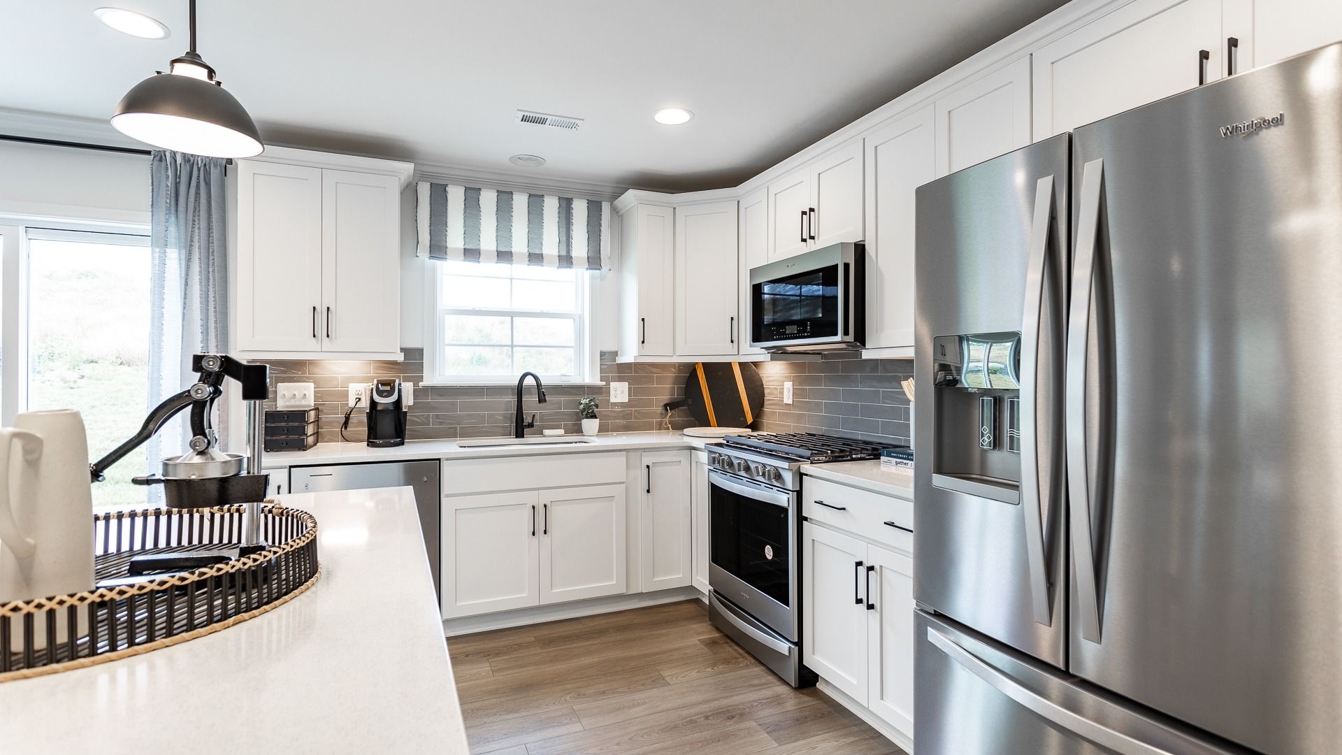 The Carnegie II kitchen is bright and functional, featuring stainless steel Whirlpool appliances.