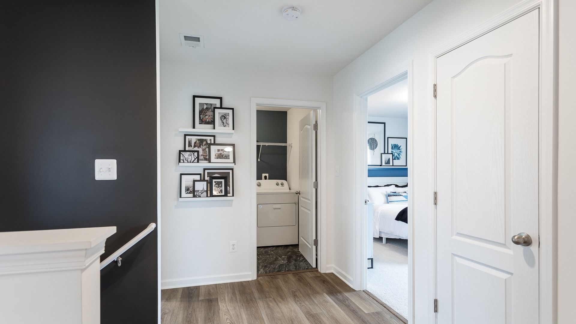 The hallway in the Carnegie II features a functional layout with a laundry closet and display space.