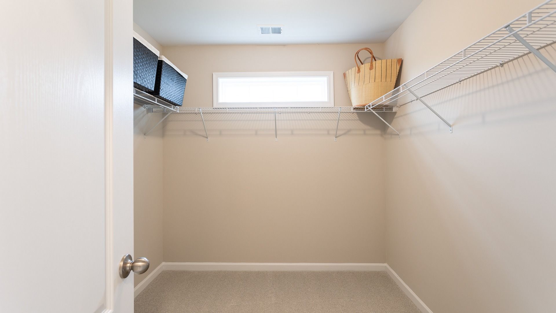 The Carnegie II features a spacious walk-in closet with ample shelving and natural light.
