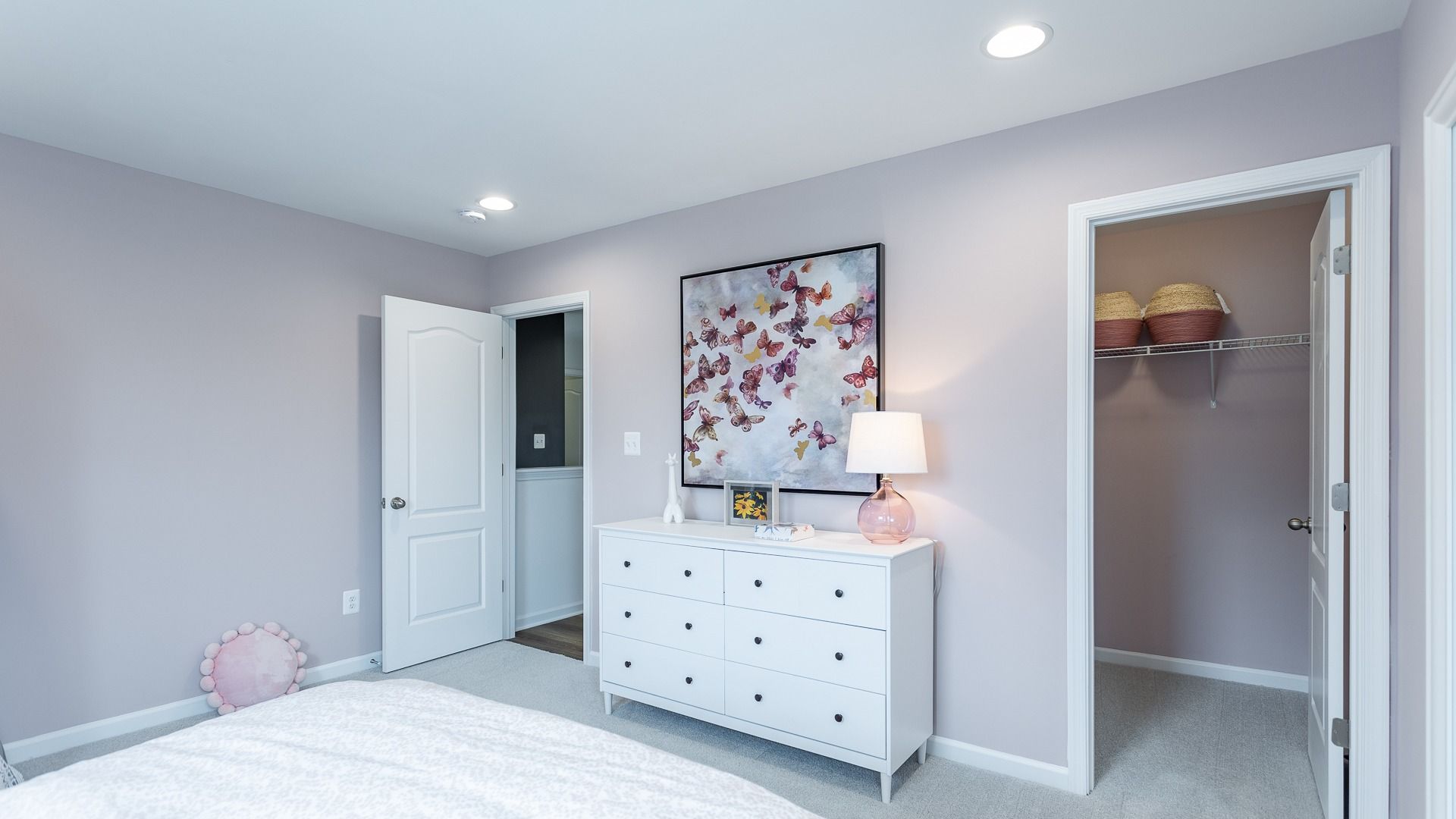 Serene bedroom in the Carnegie II features a spacious closet and plenty of room for a dresser.