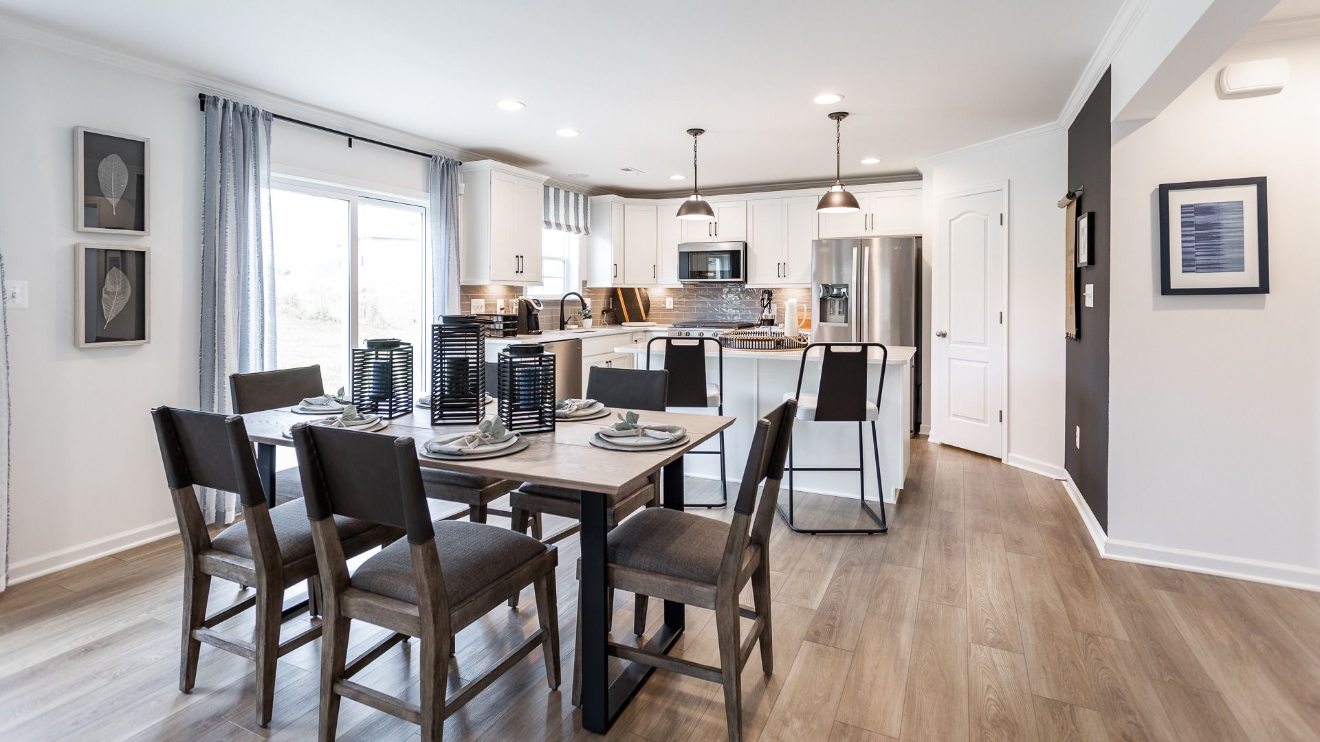 The Carnegie II kitchen features clean cabinetry, pendant lighting, and a spacious dining area.