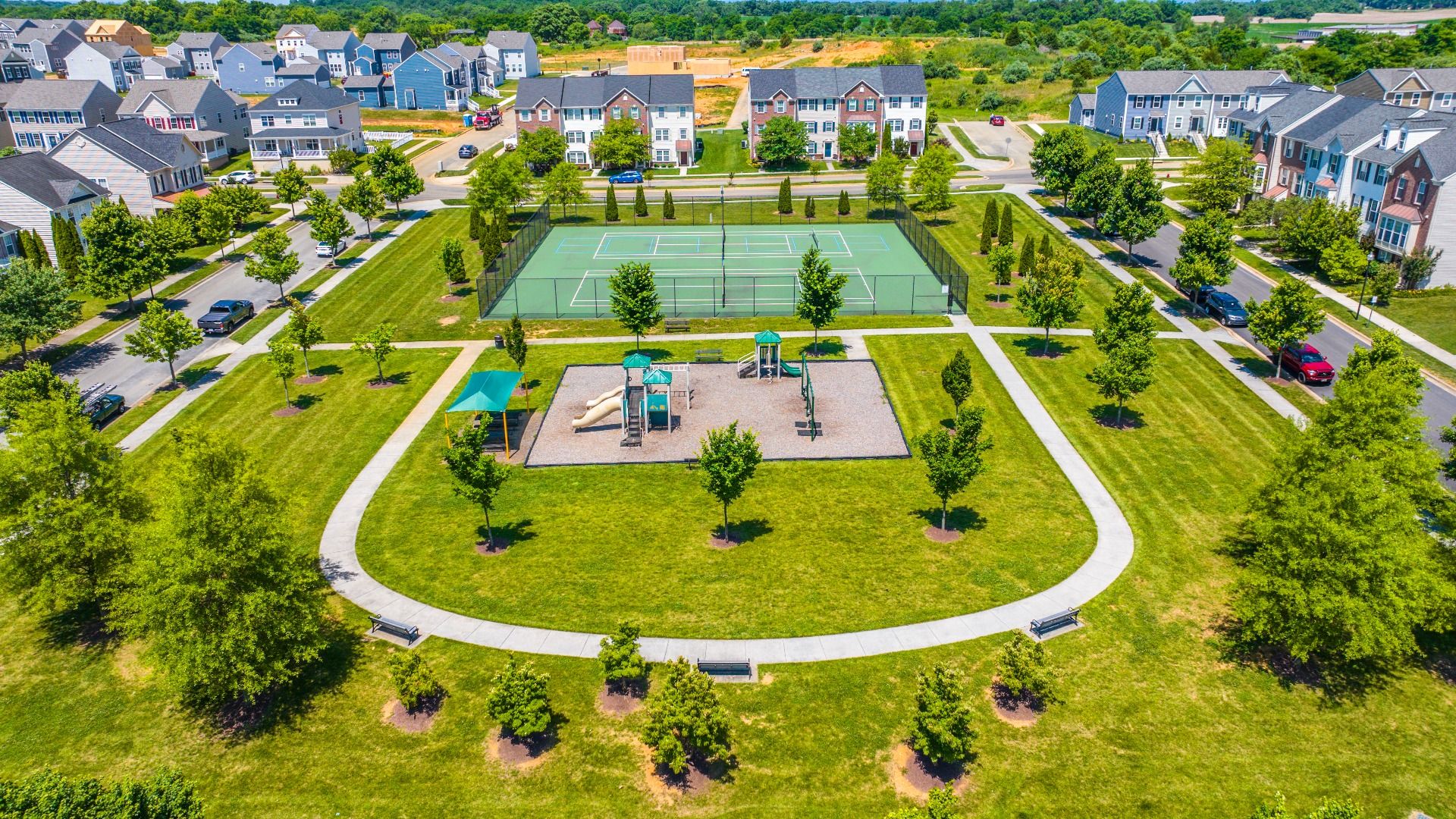 Large outdoor space with tennis courts and a lively playground at Huntfield.
