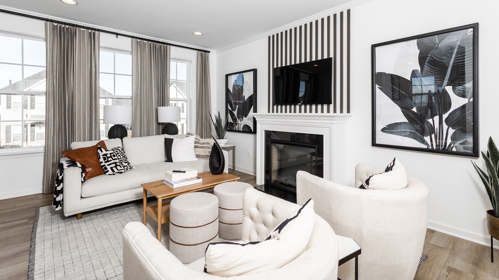 Relax in the inviting living room of the Bedford II, with cozy seating and a warm fireplace.