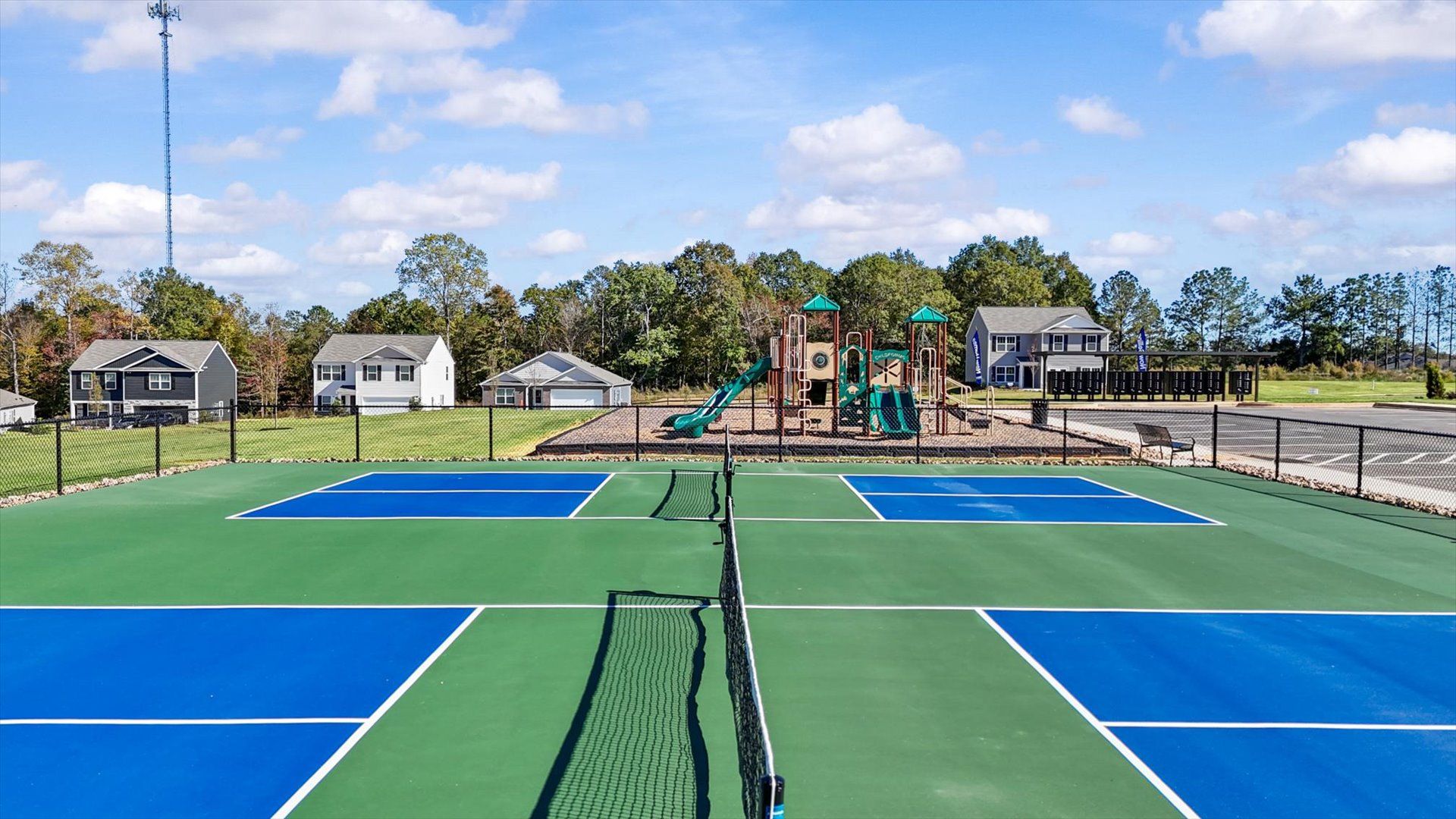Eye-catching community pickleball courts in the center of Harrier Point next to the playground