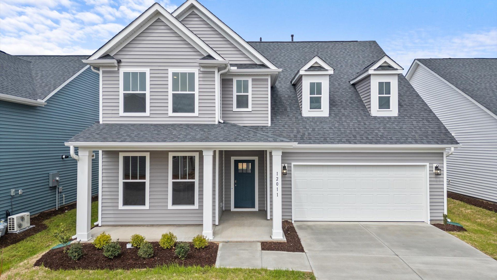 DRB Homes' Walnut Ridge Drayton floorplan with stone columns and two car garage in Inman, SC