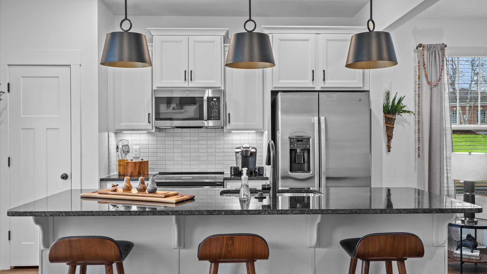 Accomplished design in a kitchen that blends function and form with a right-sized island at Gresham Station