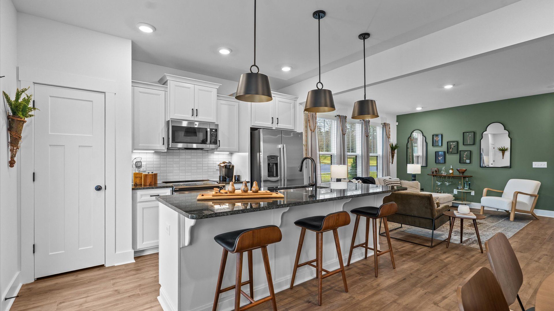 Memorable meals begin in this vibrant kitchen with pendant lighting and a thoughtfully designed island at Gresham Station
