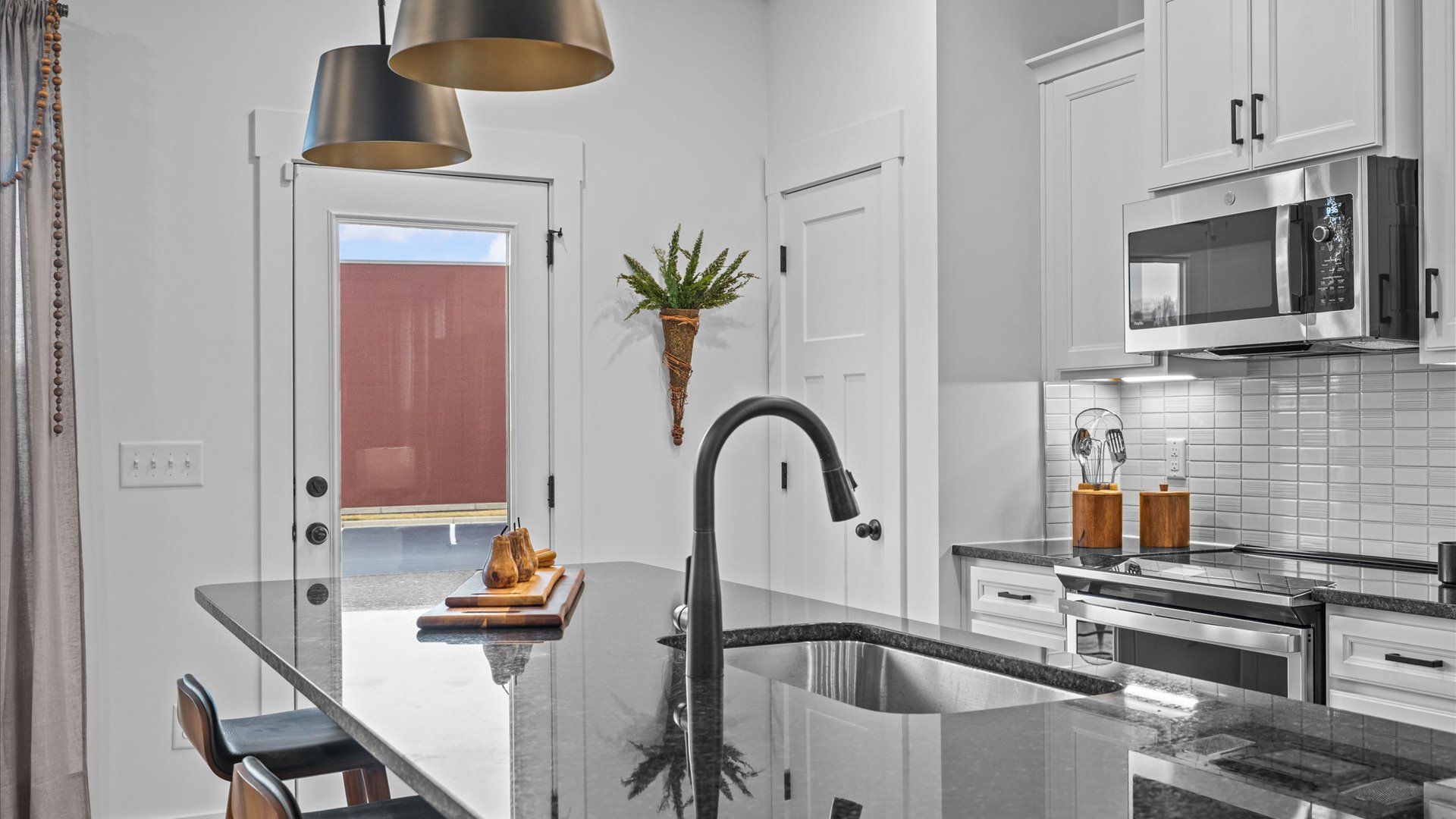 Elegant and compact island anchors this tasteful kitchen with high standards and timeless appeal at Gresham Station