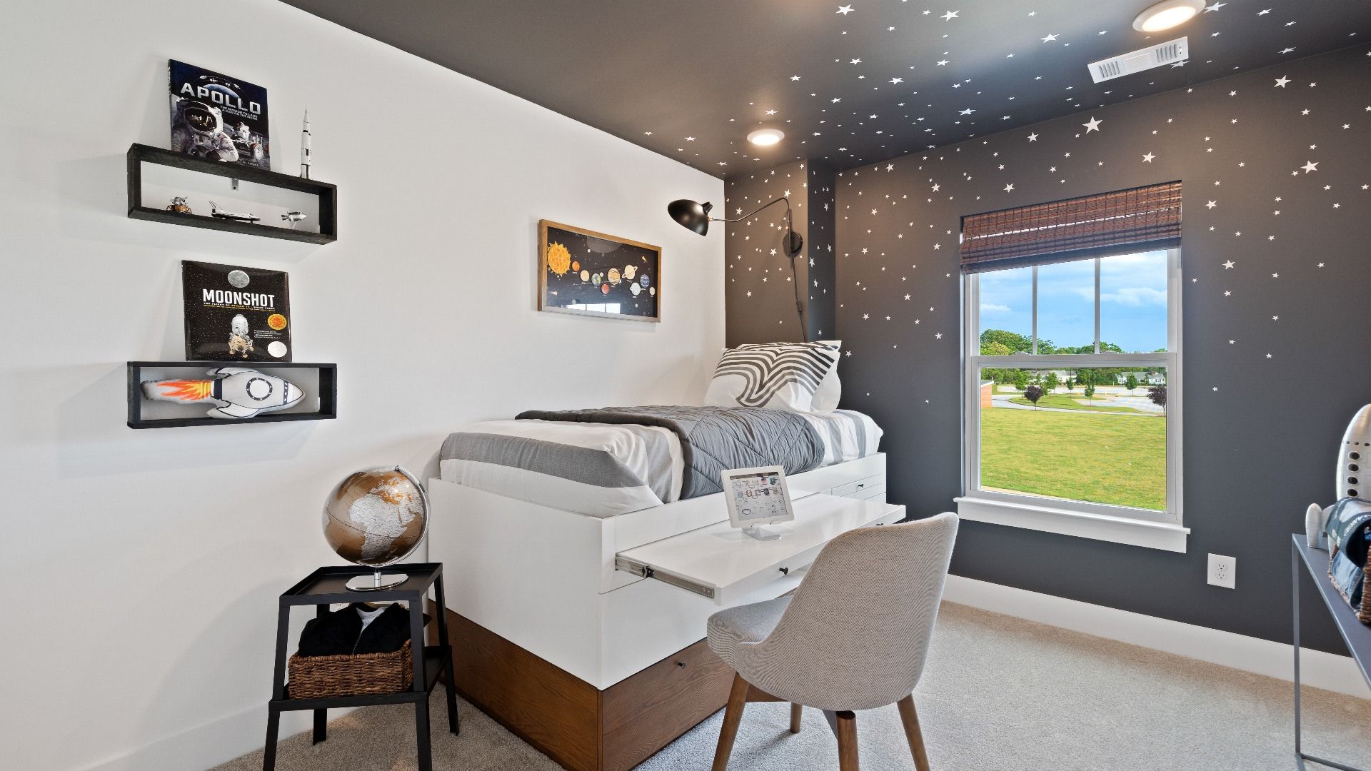 Bright and serene children's bedroom with comfortable carpeted flooring and a large window for vibrant light at Clarke Townes