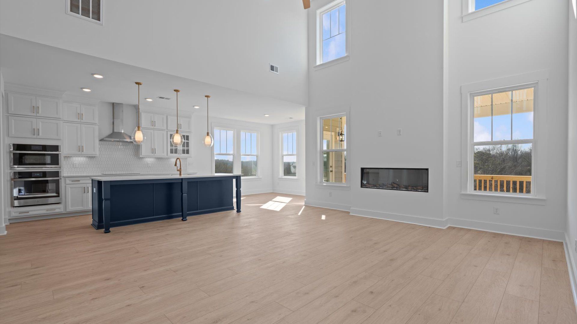 Highly skilled craftsmanship and modern elegance meet in this family room with soaring ceilings