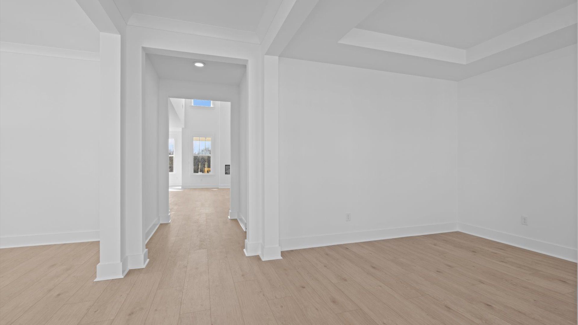 Memorable arrival experience with hardwood floors and elegant trim in the foyer