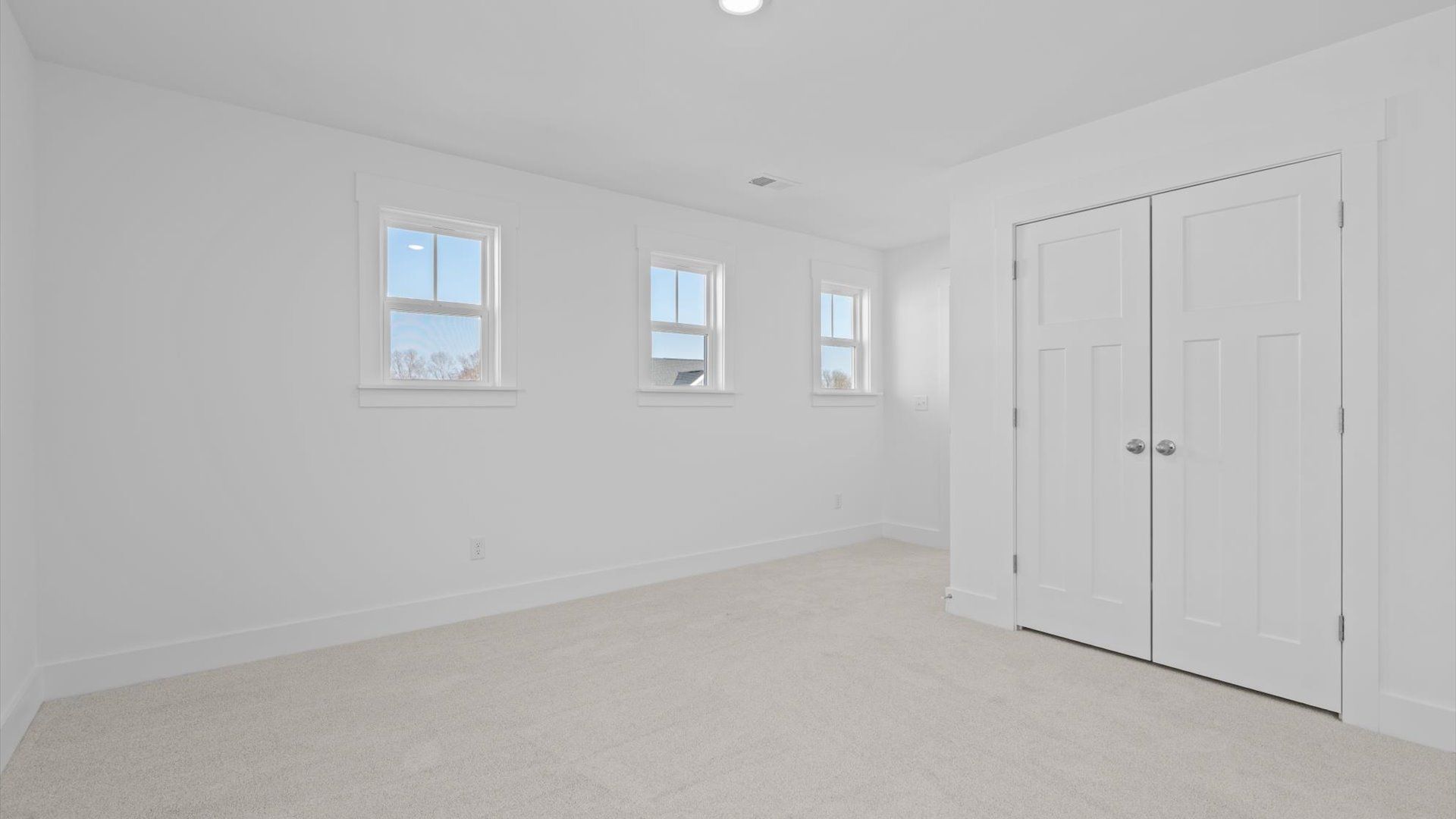 Vibrant and inviting secondary bedroom featuring a walk-in closet and refined finishes