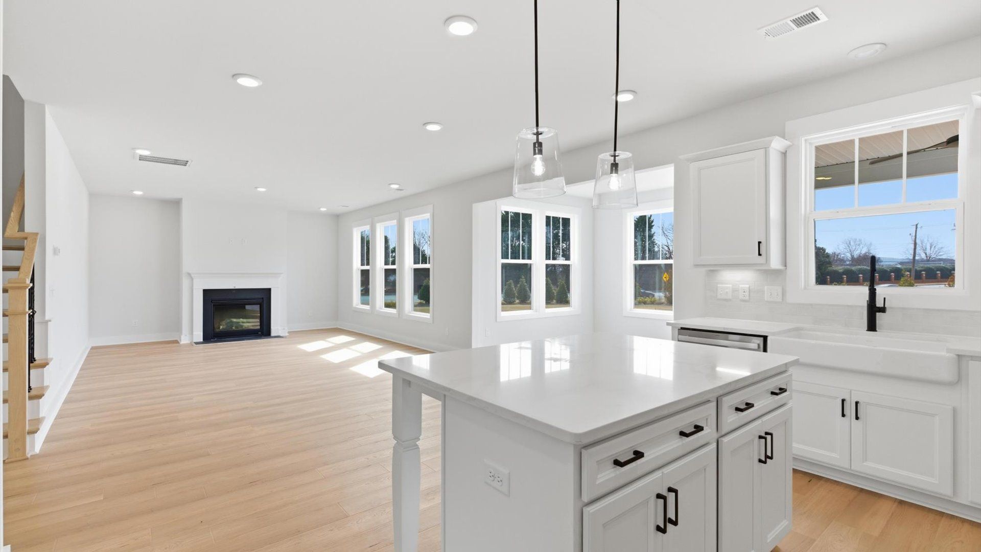 Tasteful design meets functional luxury in this kitchen with a center island and modern pendant lighting in Greenville, SC