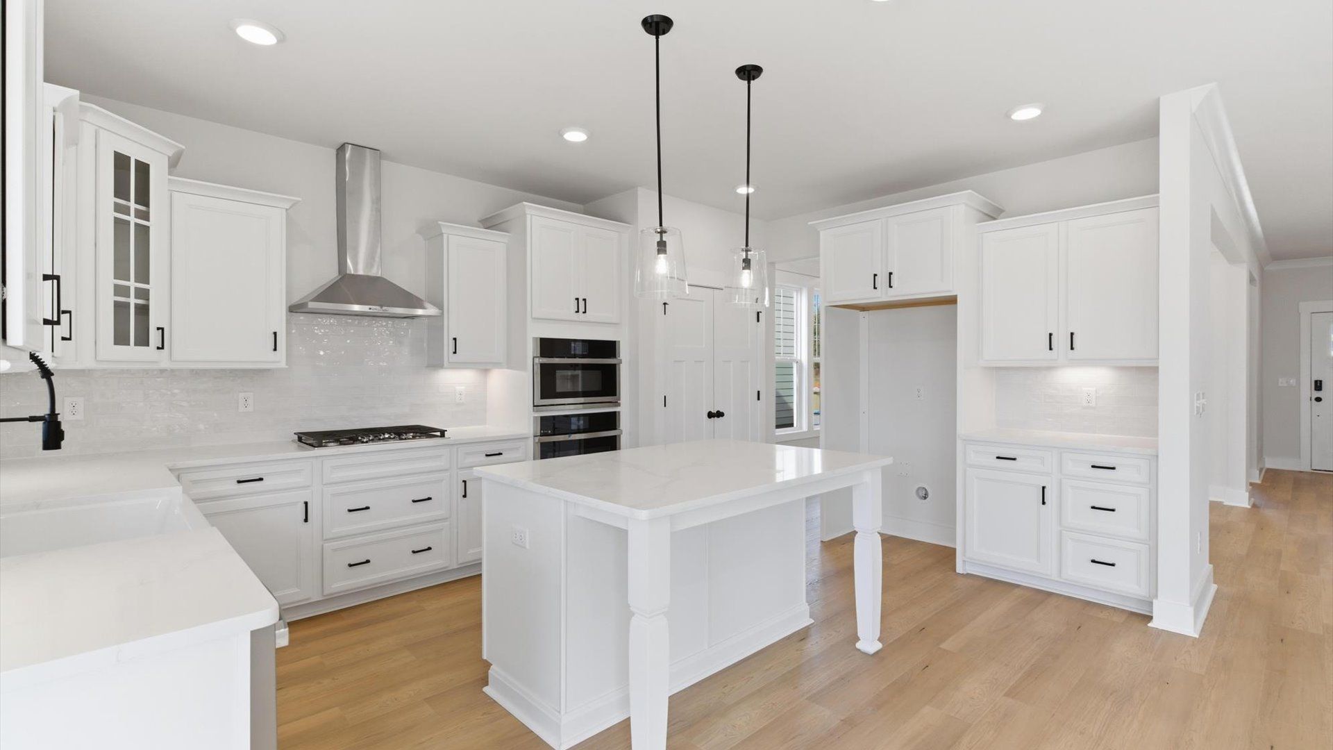 Exclusive DRB Homes kitchen with a center island, elevated finishes, and pendant lighting in a prime location