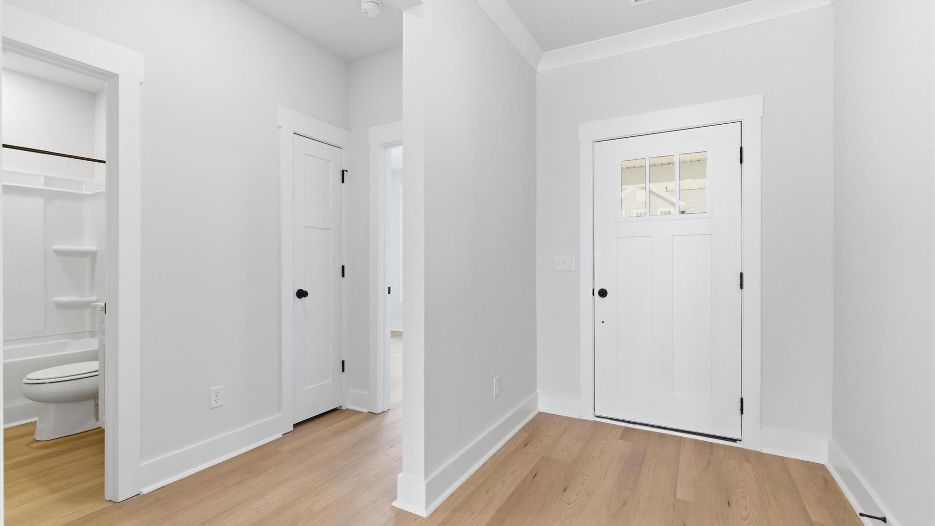 Accomplished hardwood flooring foyer sets the tone for tasteful design throughout the home at Pelham Crossing