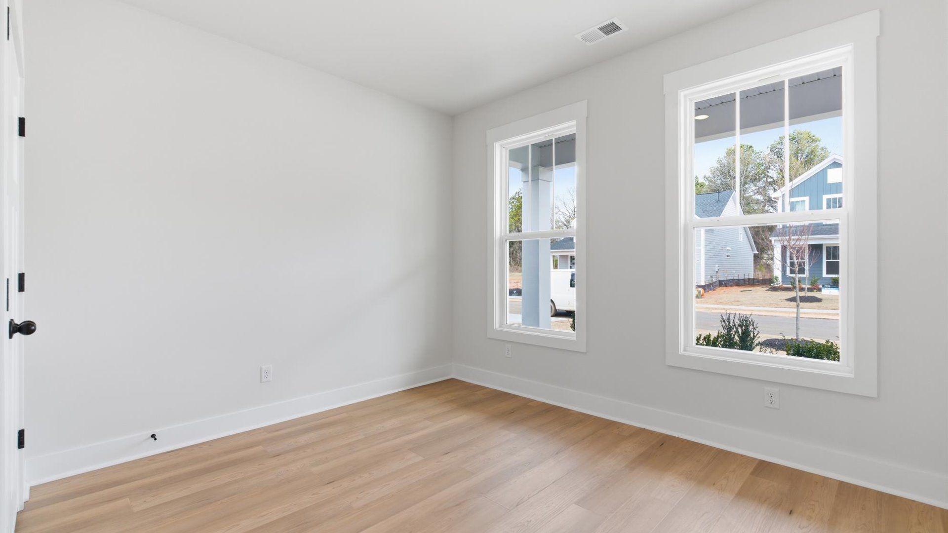 Vibrant natural light and tasteful design define this home office space near the front of the home at Pelham Crossing