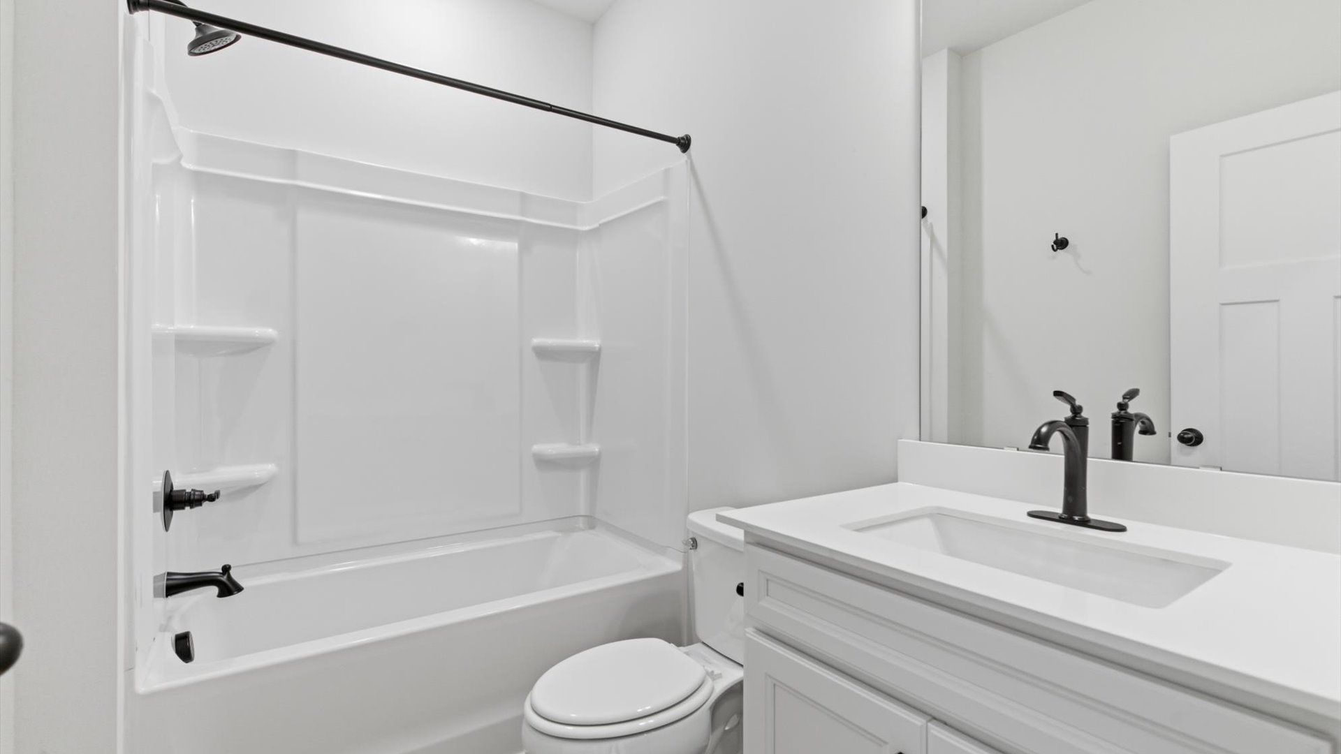 Refined hall bath with elevated finishes and a highly functional layout at the Pelham Crossing community