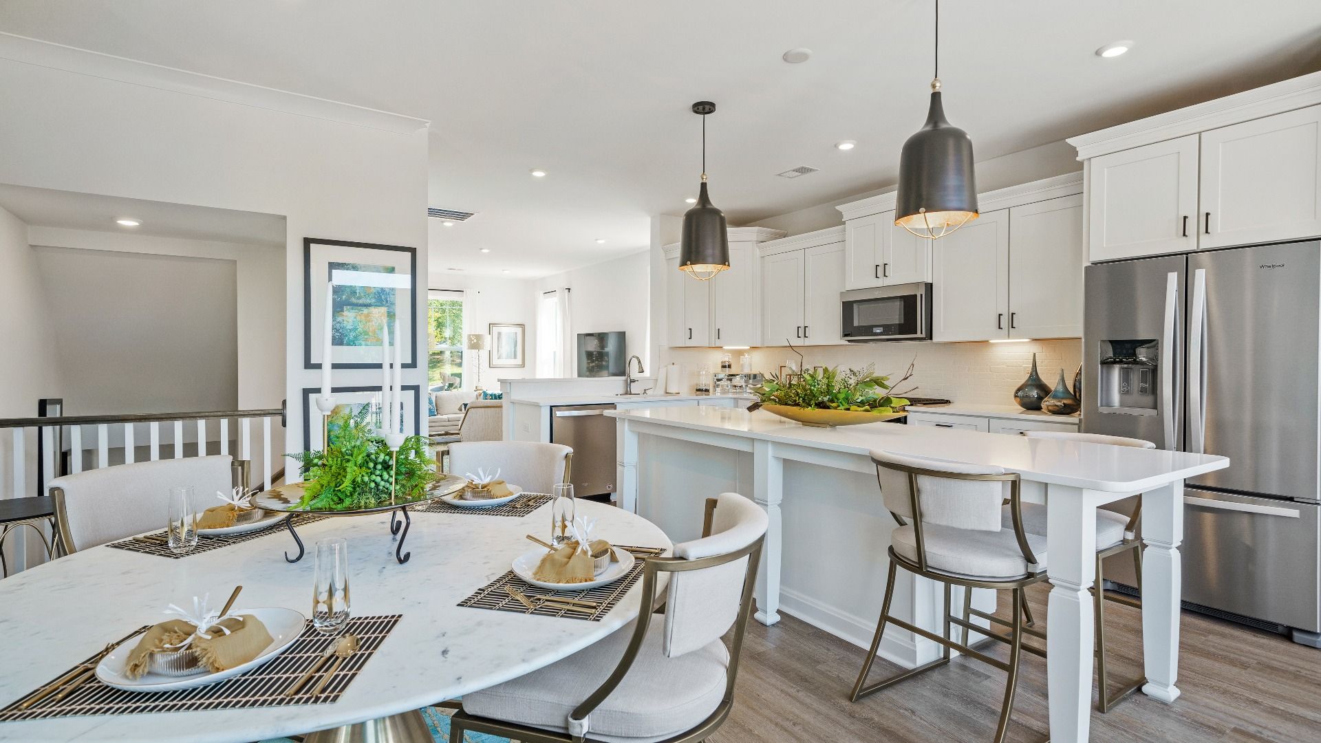 Elegant kitchen featuring a 9-foot island with pendant lighting and tasteful finishes throughout at Montgomery Chase