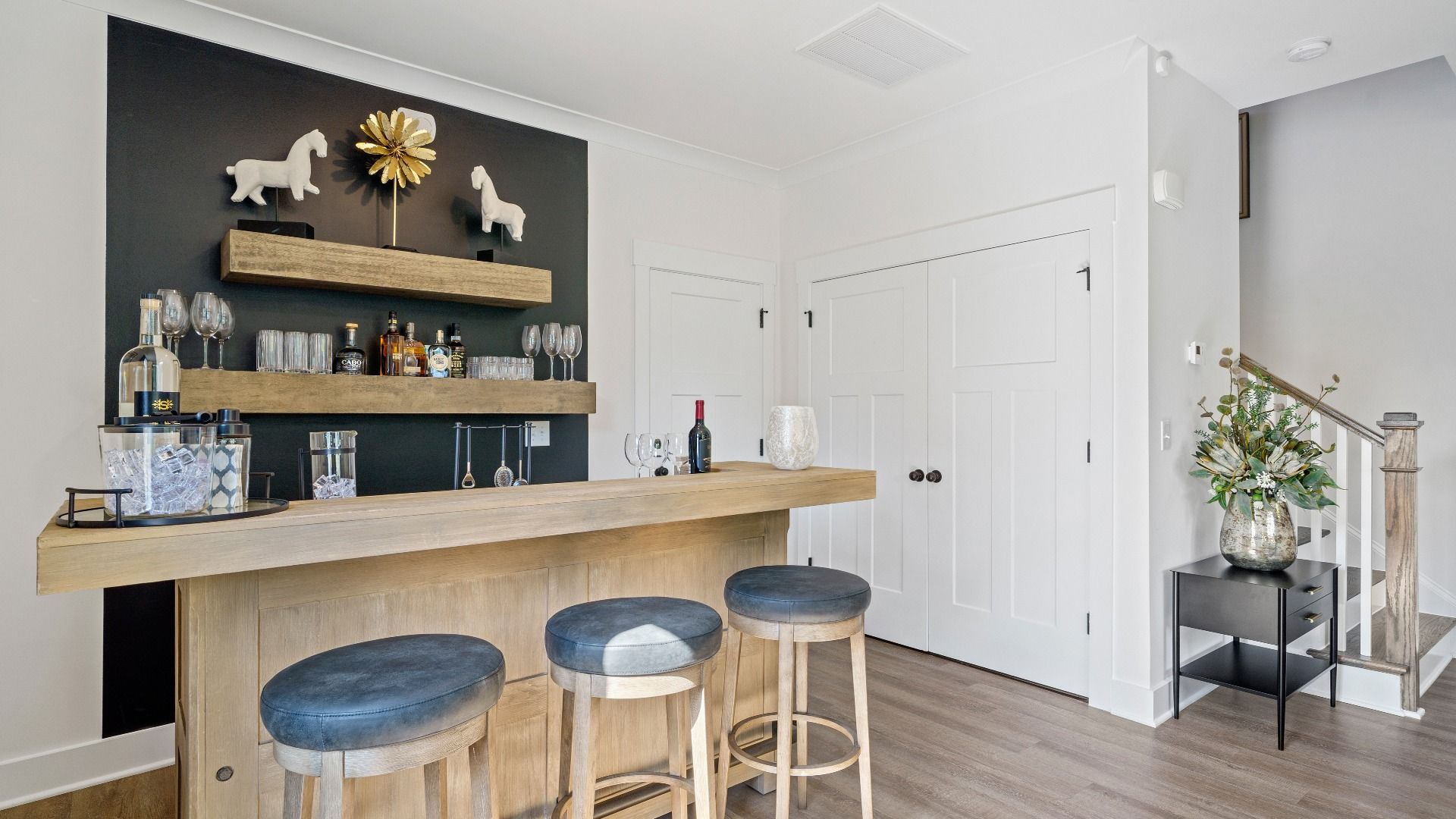 Eye-catching room with elegant millwork and seamless access to dining and kitchen at the new Montgomery Chase community