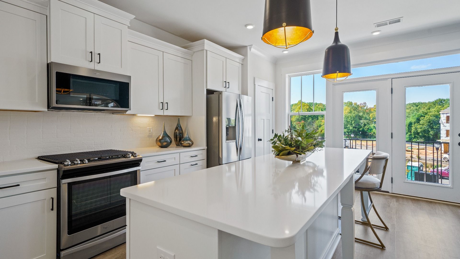 Memorable meals begin in this vibrant kitchen with pendant lighting and a thoughtfully designed island at Montgomery Chase
