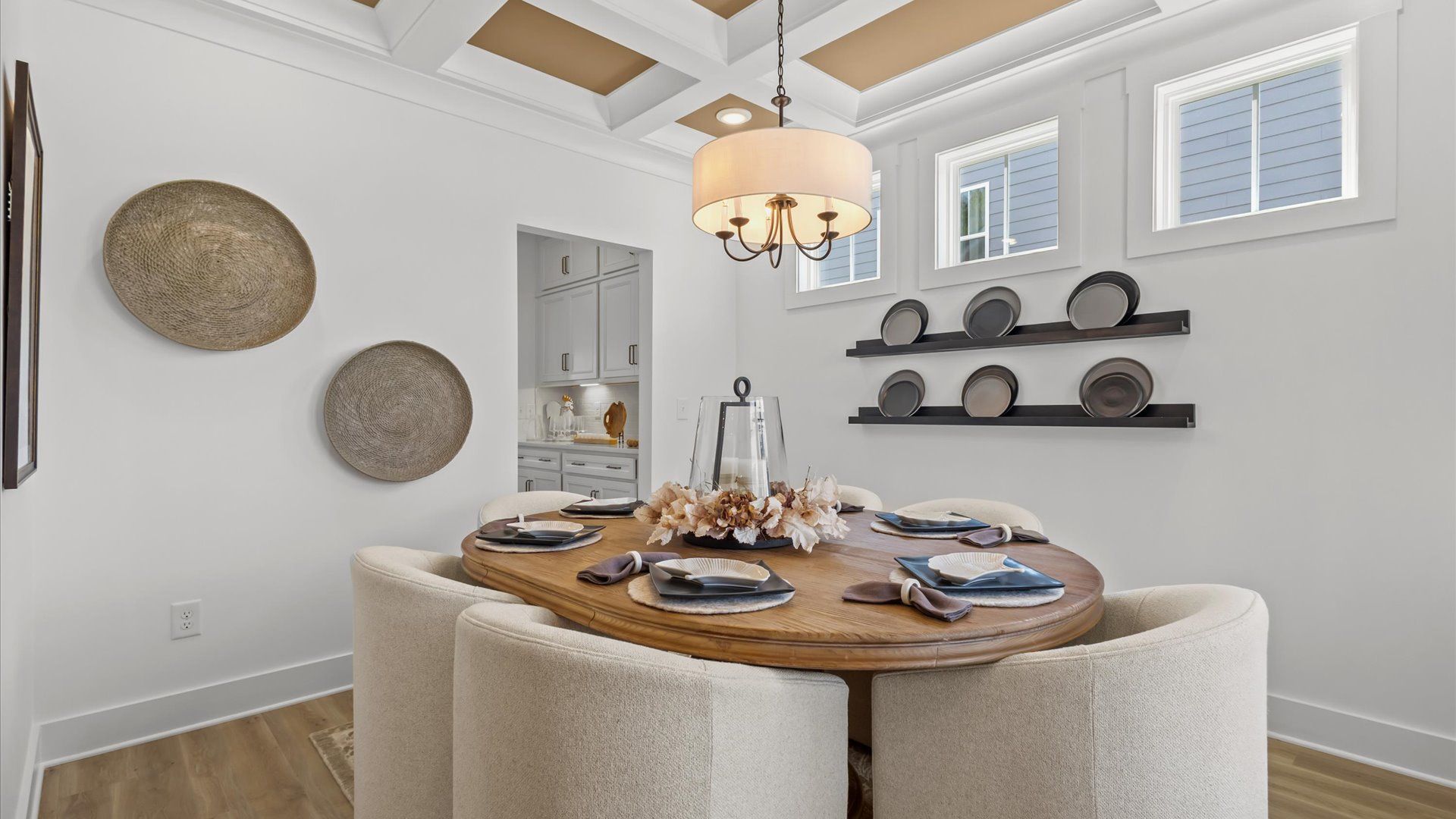 Notable coffered ceiling elevates this accomplished dining room in Greenville, SC